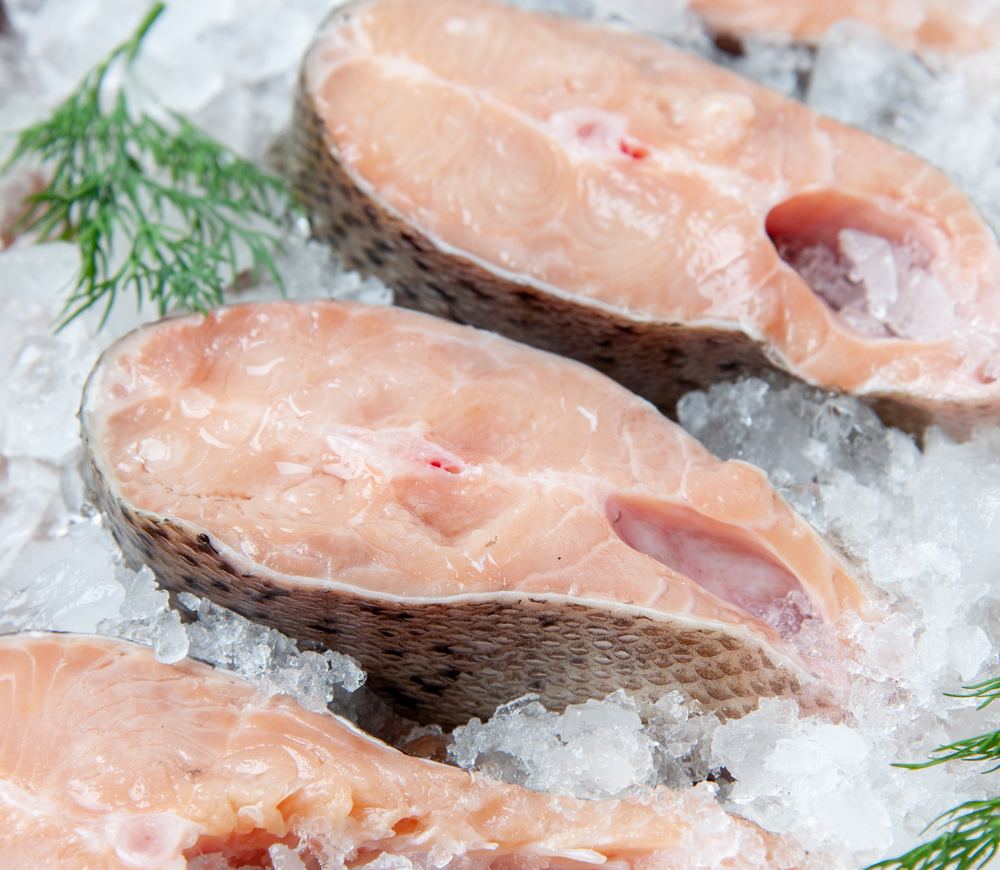 Sliced fish steaks packed on crushed ice